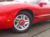 Camaro "Veggie Cutter" style wheels.  Note painted cap with Firebird emblem.